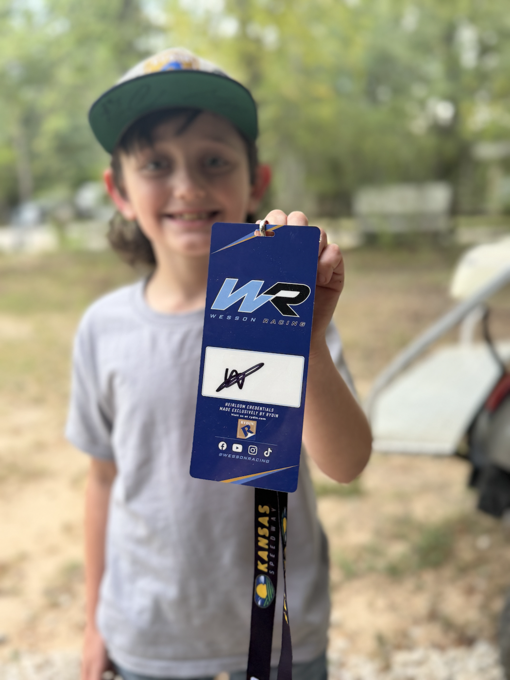 Back of the Wesson Racing fan credential showing Wesson's autograph and attached lanyard