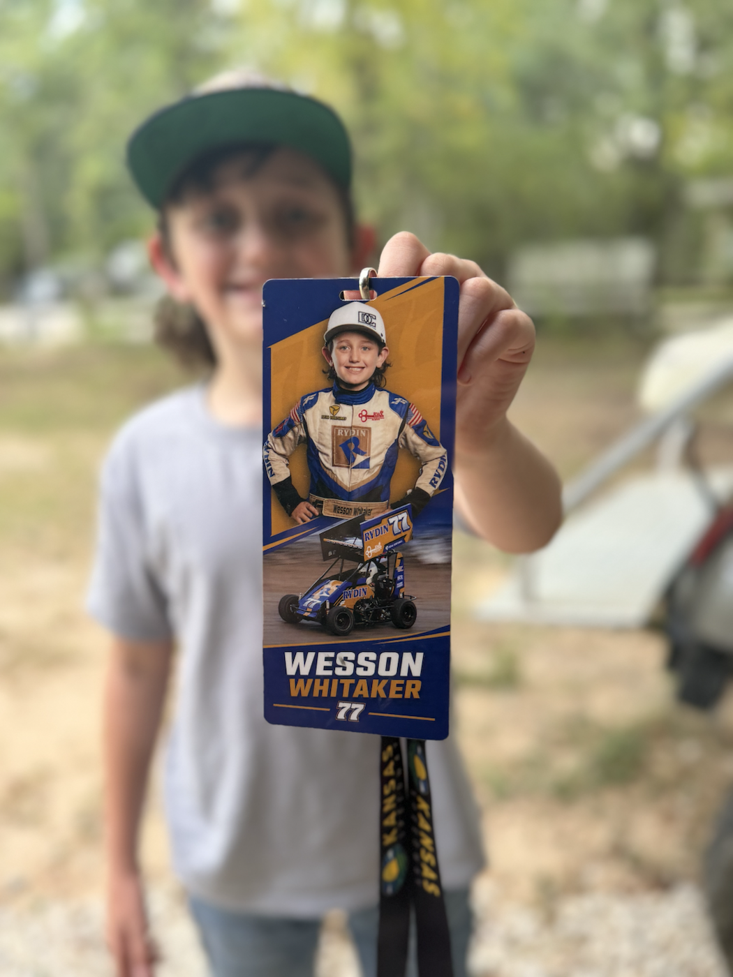 Wesson holding his No. 77 racing fan credential and lanyard